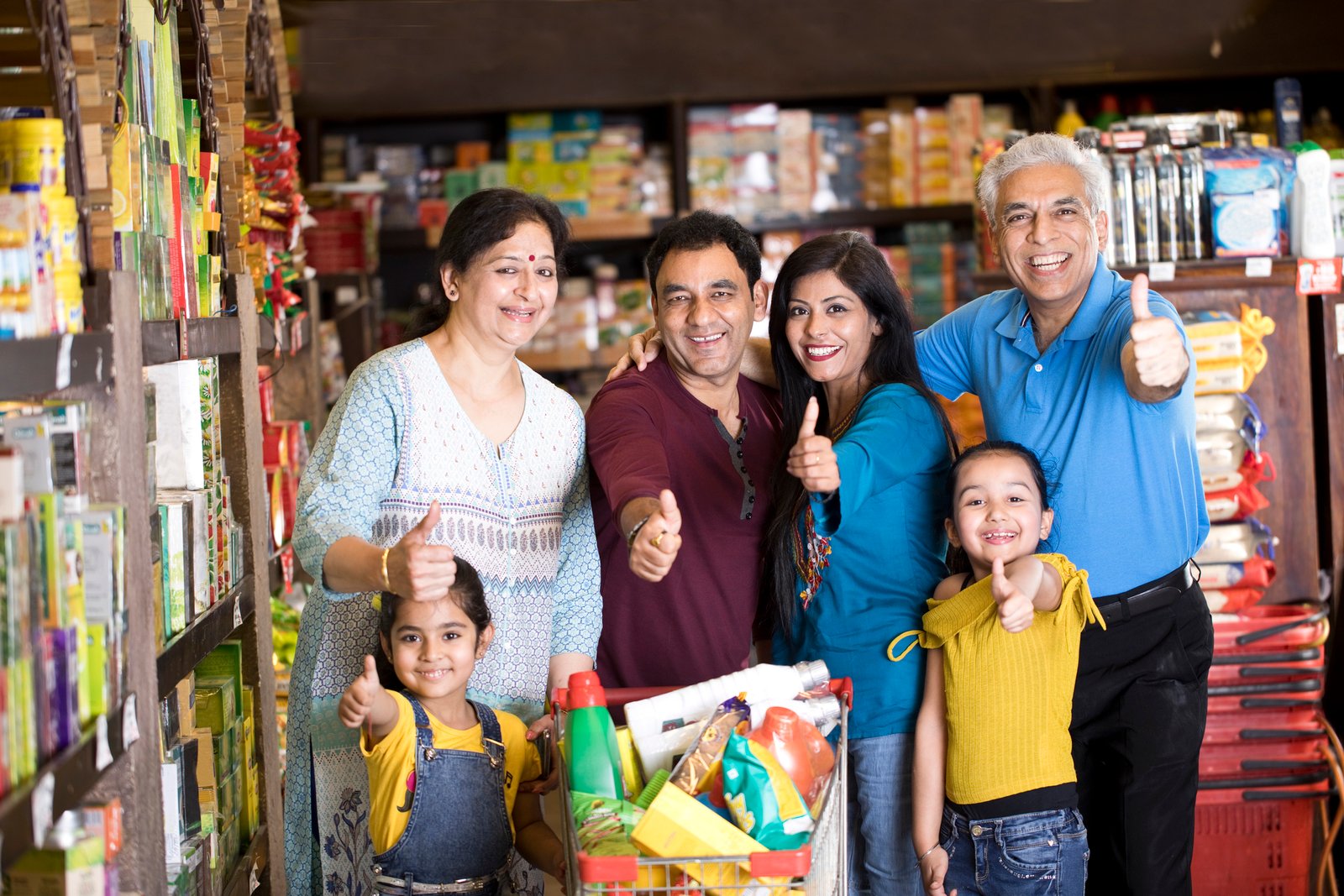 Happy Indian multi-Generation family shopping at supermarket